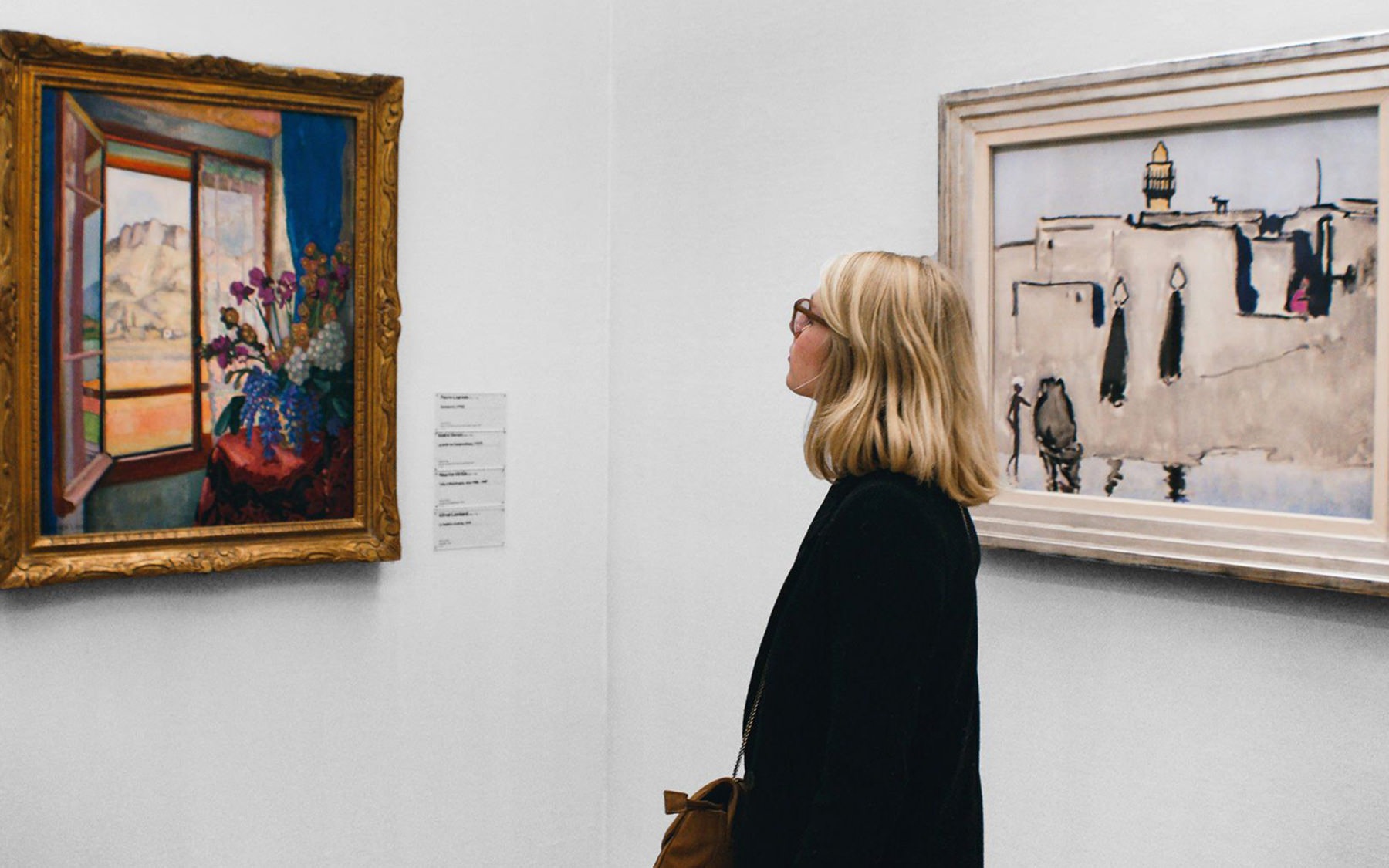 woman in museum admiring a piece of art