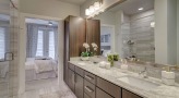 well lit bathroom with brown accents 