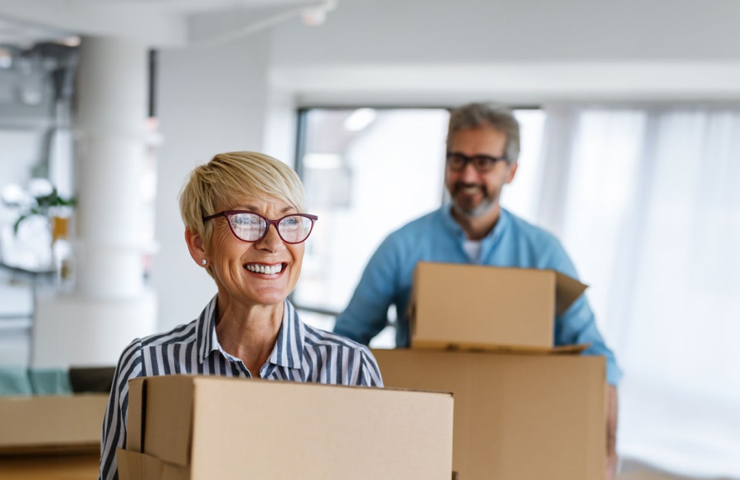 Senior couple boxing up items in their home and preparing to move