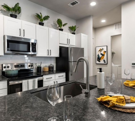 kitchen area with bright cabinets and granite island