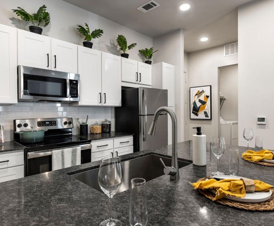 kitchen area with bright cabinets and granite island