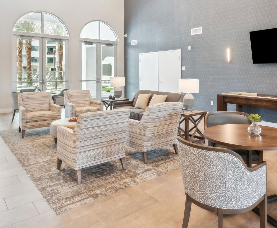 resident lounge with large windows and plenty of seating