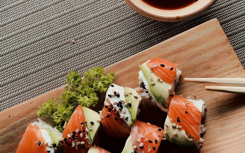 raw sushi on wooden plank
