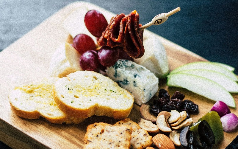Nearby Activities & Attractions small charcuterie board with bread, apples, nuts, grapes, and meat