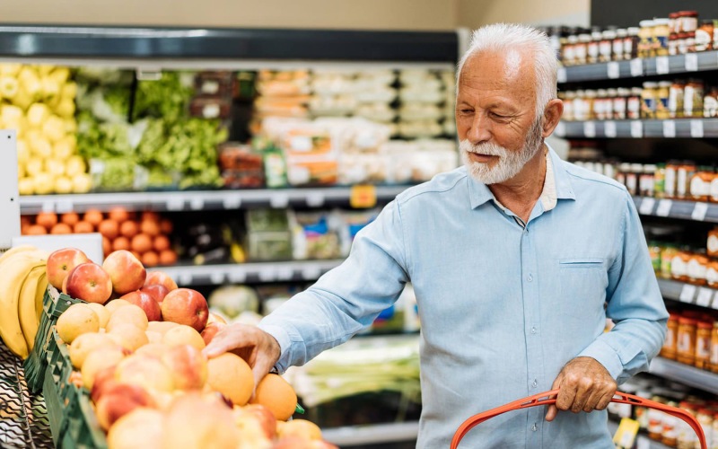man in grocery store shopping for produce