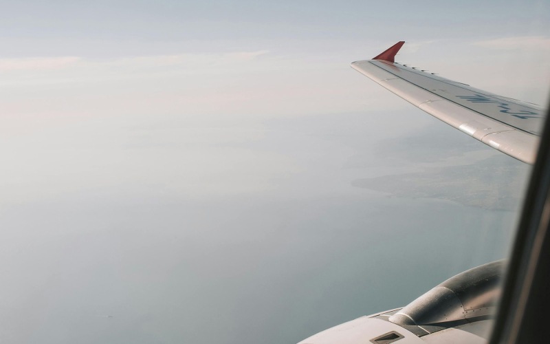 window perspective of airplane's wing in the air