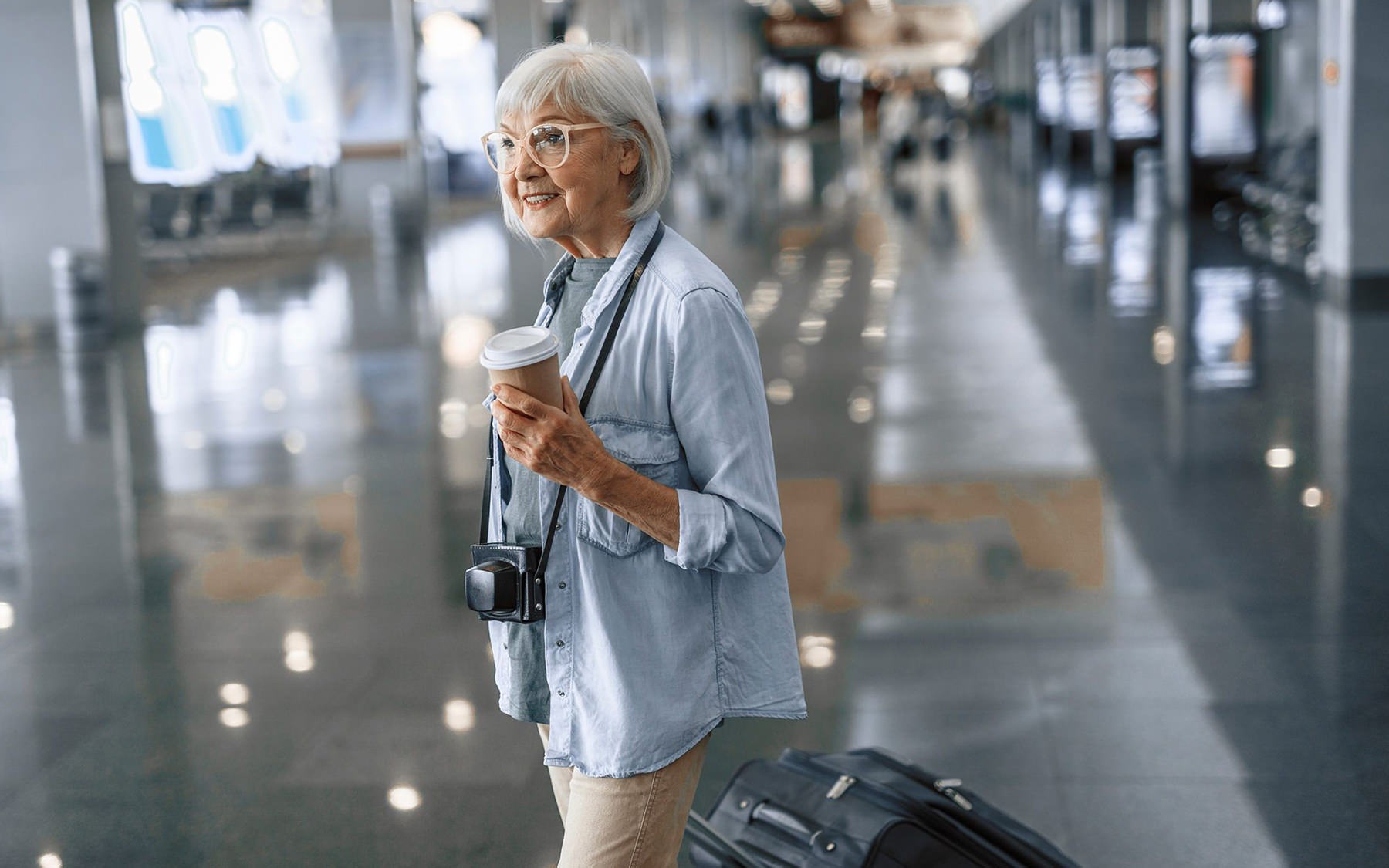 Woman walking in airport with luggage