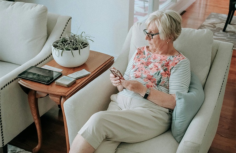 a woman in a chair on a smartphone