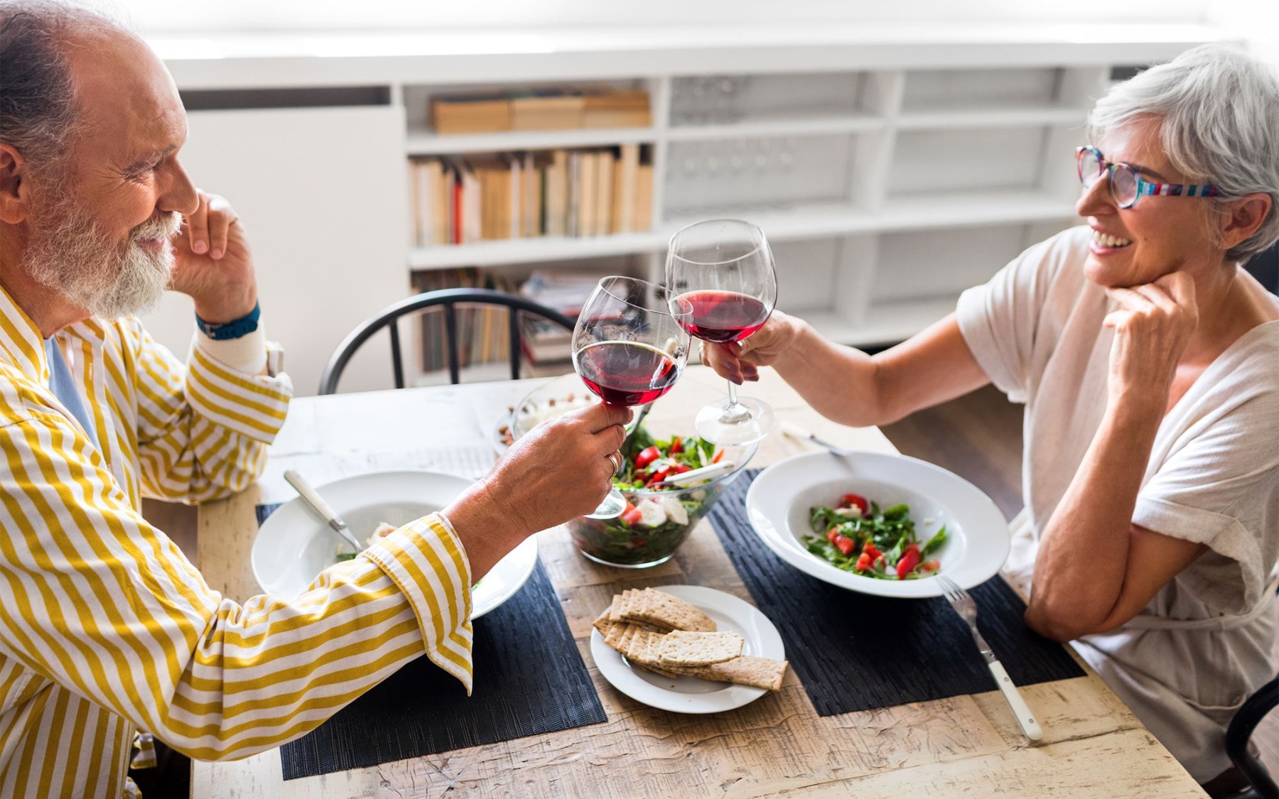 The essence of exceptional living a couple sits at a table eating with wine