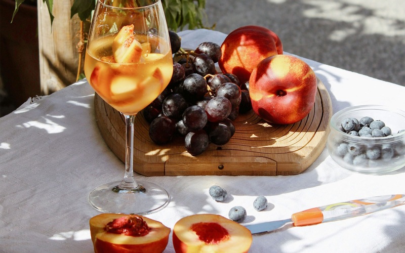 Bustling community with plenty of dining choices a board of fruit and a glass of wine