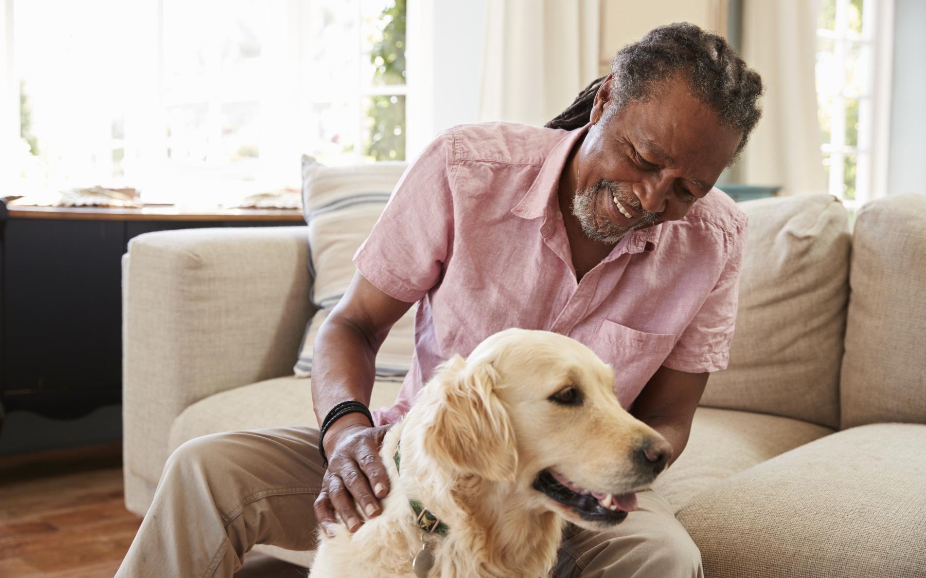 It’s Time to Rethink Your Best Life a man sitting on a couch with a dog