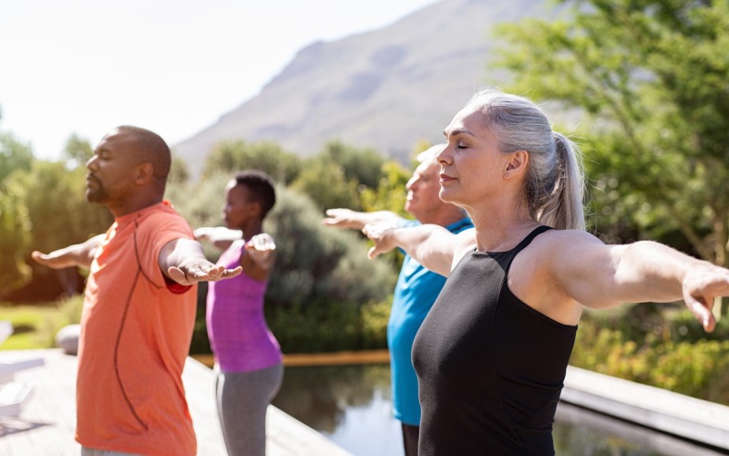 a group of people exercising outside
