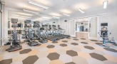 Large fitness center with large windows and plenty of equipment