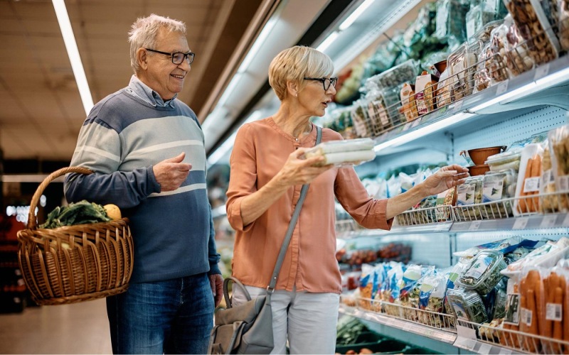 a man and woman grocery shopping