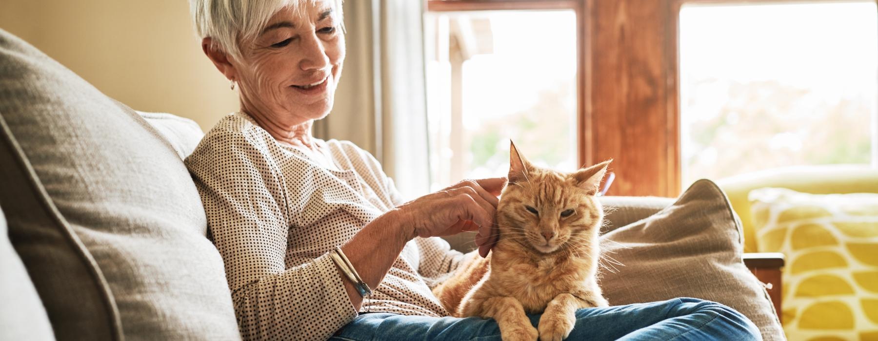 Woman and her cat sitting on the couch 