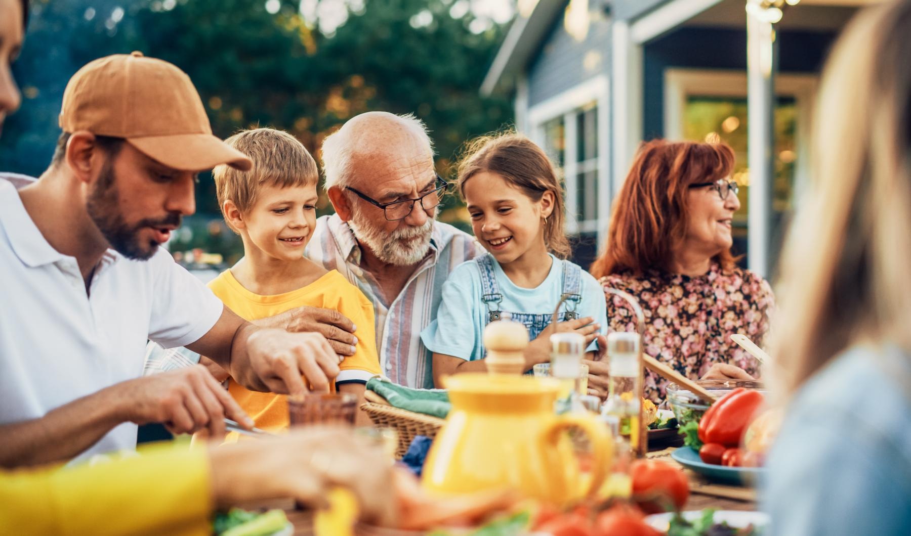 Lifestyle A family sitting outside at Overture Rancho Santa Margarita over 55 apartments in Orange County, CA.