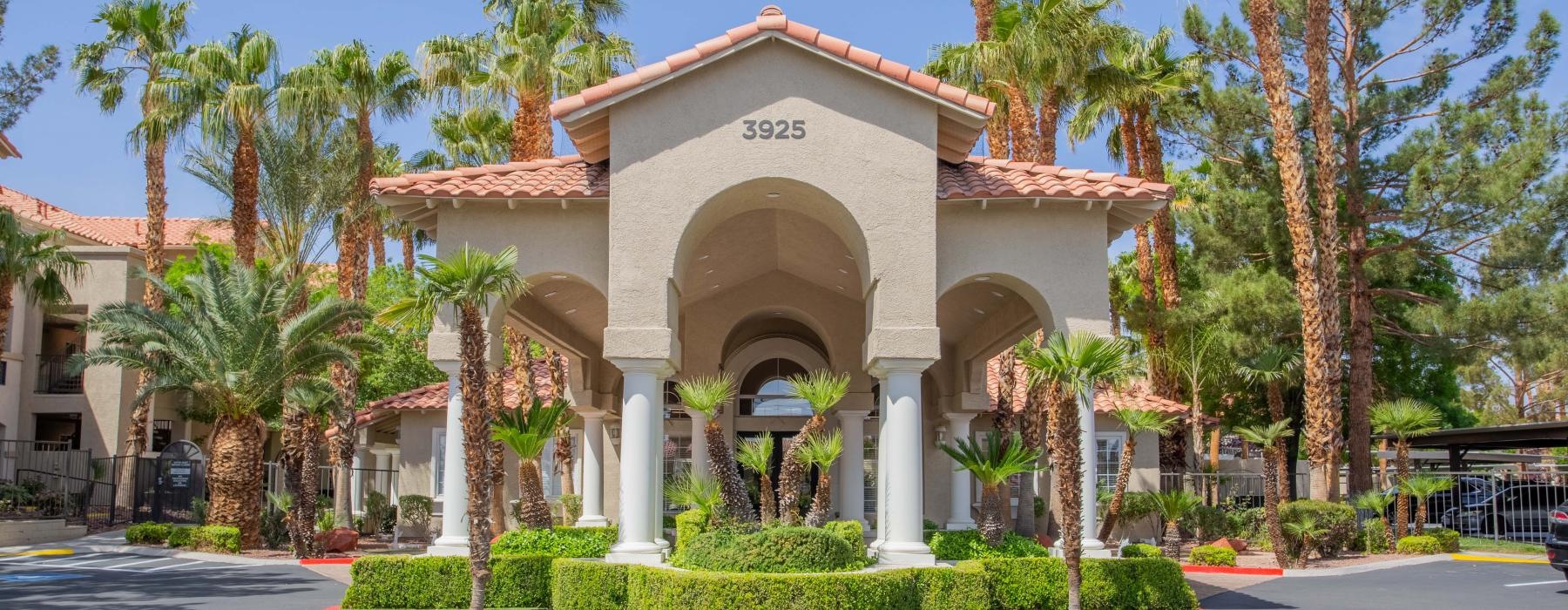 entrance to a building surrounded by palm trees