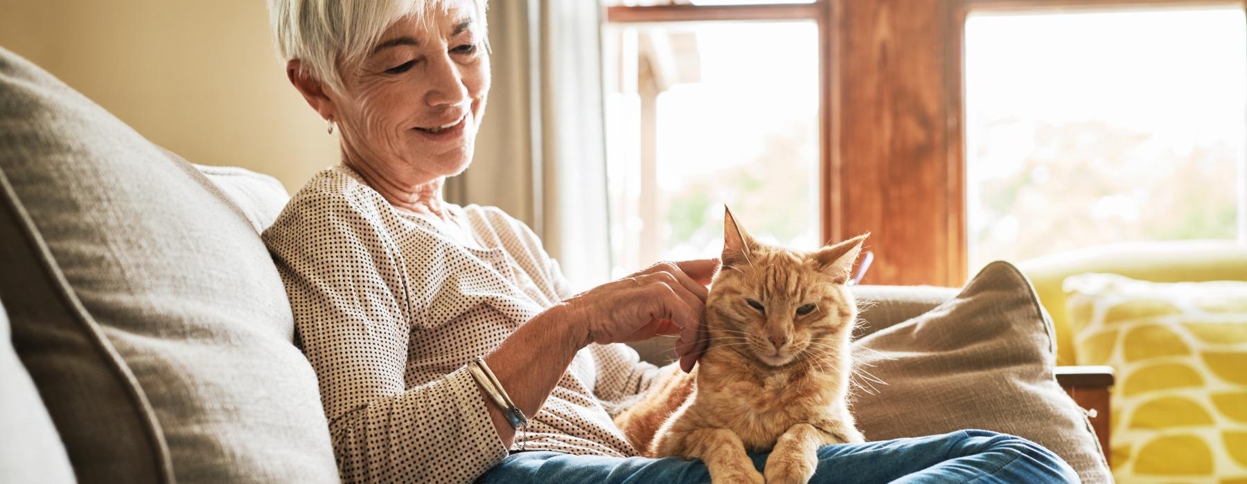 Woman sitting in her living room with her cat