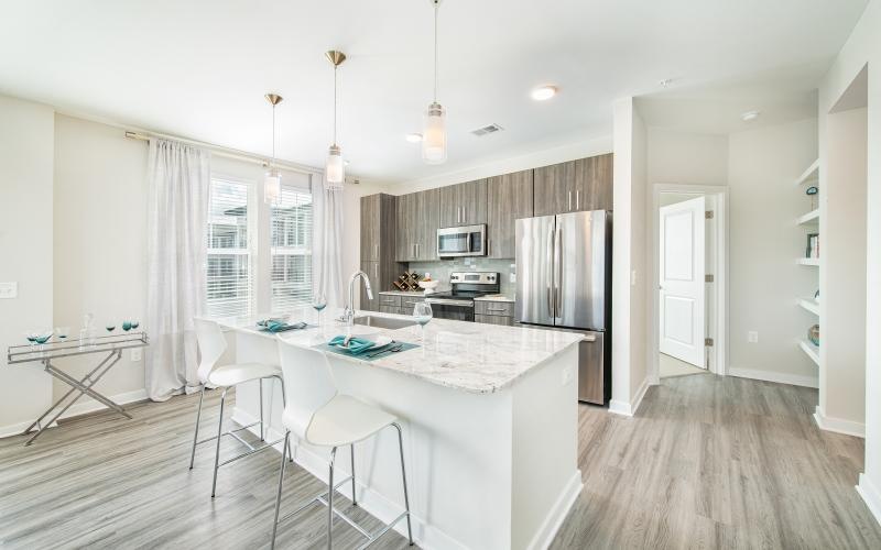 a kitchen with an island and chairs