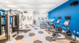 Large fitness center with large windows and plenty of equipment