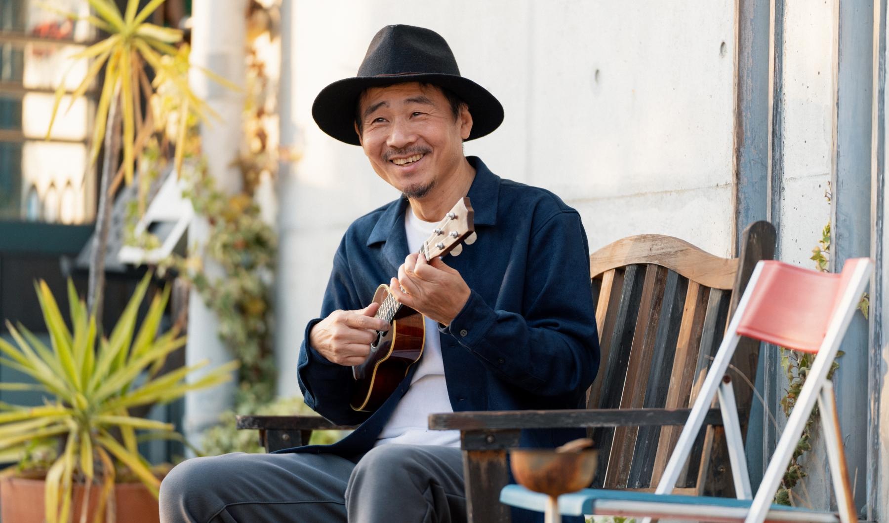 Your Joy to Embrace Someone playing the ukulele at Overture Sugar Land Senior Living Apartments in Sugar Land, TX, featuring natural lighting.